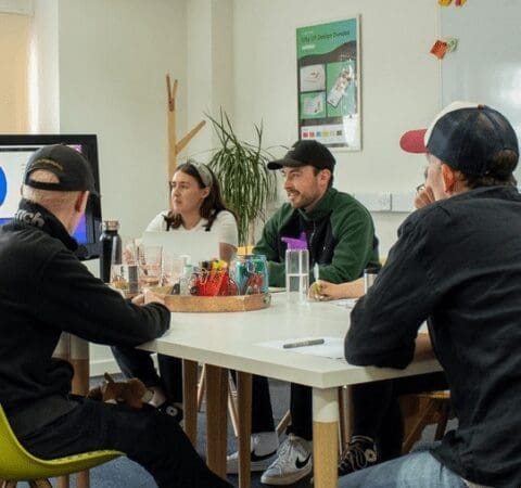 a group of people sitting around a table