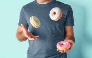man juggling donuts